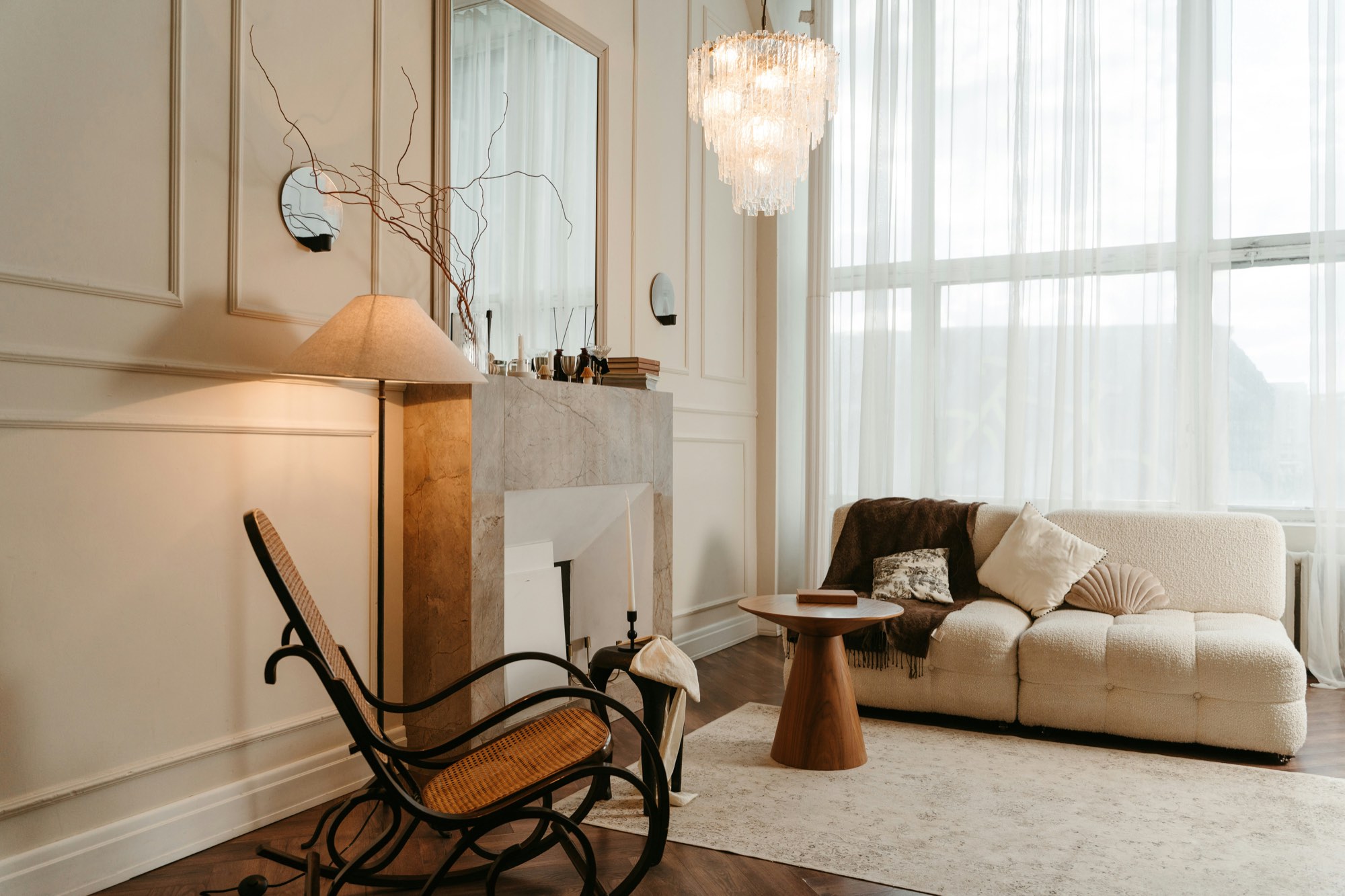 A bright living room with a rocking chair and a low sofa